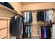 Organized walk-in closet with ample hanging space and built-in shelving for storage at 11460 W Tanforan Cir, Littleton, CO 80127