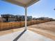 A covered patio overlooks the backyard with a wooden privacy fence at 6092 Corral St, Brighton, CO 80601