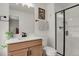 Modern bathroom featuring stylish vanity, framed mirror, and glass shower at 7325 S Waterloo Way, Aurora, CO 80016