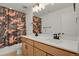 Large bathroom with dual sinks, vanity, and tub with camouflage curtain at 7325 S Waterloo Way, Aurora, CO 80016