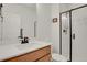 Bathroom featuring a white quartz countertop and a sleek, glass-enclosed shower at 7325 S Waterloo Way, Aurora, CO 80016