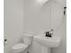 Clean and simple half-bath features a pedestal sink, toilet, and modern fixtures at 7325 S Waterloo Way, Aurora, CO 80016