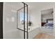 Elegant bathroom showcasing a glass-enclosed shower and a soaking tub with black trim at 7325 S Waterloo Way, Aurora, CO 80016