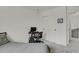 Simple bedroom with desk and a bed; sliding closet doors at the end of the room at 7325 S Waterloo Way, Aurora, CO 80016