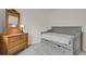 Cozy bedroom with window view, vintage dresser, and a comfortable bed at 7325 S Waterloo Way, Aurora, CO 80016