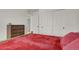 Bright bedroom featuring white walls, closet, dresser, and comfortable bed at 7325 S Waterloo Way, Aurora, CO 80016