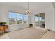 Bright dining room featuring large windows with neighborhood views and a sliding door to an outdoor space at 7325 S Waterloo Way, Aurora, CO 80016