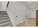 Hallway with staircase and view of open office space with hardwood floors at 7325 S Waterloo Way, Aurora, CO 80016
