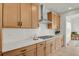 Kitchen featuring wood cabinets, stainless steel appliances, white countertops, and a tile backsplash at 7325 S Waterloo Way, Aurora, CO 80016