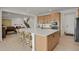 Open-concept kitchen featuring a large island with bar seating, stainless steel appliances, and lots of cabinets at 7325 S Waterloo Way, Aurora, CO 80016