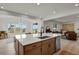Eat-in kitchen with large island, stainless steel appliances, pendant lighting, and an open floor plan at 7325 S Waterloo Way, Aurora, CO 80016
