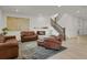 Comfortable living room with a cozy fireplace, plush seating, and staircase at 7325 S Waterloo Way, Aurora, CO 80016