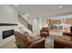 Spacious living room with a fireplace, plush seating, and open view to the kitchen at 7325 S Waterloo Way, Aurora, CO 80016