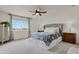 Well-lit main bedroom featuring a comfortable bed and two nightstands with lamps at 7325 S Waterloo Way, Aurora, CO 80016
