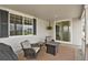 Relaxing covered patio with woven furniture and pleasant outdoor ambiance at 7325 S Waterloo Way, Aurora, CO 80016