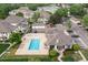 Aerial view of the community pool, clubhouse, and surrounding residences at 8707 E Florida Ave # 614, Denver, CO 80247