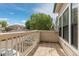 Balcony with a light-colored wood railing overlooking the neighborhood street at 8707 E Florida Ave # 614, Denver, CO 80247
