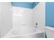 Bathroom with a bathtub and white tiles at 8707 E Florida Ave # 614, Denver, CO 80247
