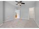 Neutral carpeted bedroom, ceiling fan, and doors to bathroom and closet at 8707 E Florida Ave # 614, Denver, CO 80247