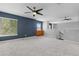 A carpeted upstairs bonus room with two ceiling fans and two windows at 8707 E Florida Ave # 614, Denver, CO 80247