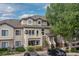 Inviting townhome with a covered entrance, upper balcony, and neat landscaping for a welcoming feel at 8707 E Florida Ave # 614, Denver, CO 80247