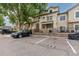 Exterior of the condo featuring parking spaces and a manicured lawn at 8707 E Florida Ave # 614, Denver, CO 80247