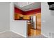 Kitchen with stainless steel appliances, wood cabinets, and a bold red accent wall at 8707 E Florida Ave # 614, Denver, CO 80247