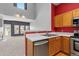 Eat-in kitchen featuring wood cabinets, stainless steel appliances, and barstool seating at 8707 E Florida Ave # 614, Denver, CO 80247