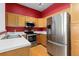 The kitchen features stainless steel appliances, white countertops, and wood flooring at 8707 E Florida Ave # 614, Denver, CO 80247