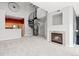 Bright living room featuring a spiral staircase, fireplace, and an open layout to the kitchen at 8707 E Florida Ave # 614, Denver, CO 80247