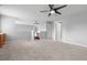 Spacious loft area with ceiling fan, soft carpet, and access to other rooms at 8707 E Florida Ave # 614, Denver, CO 80247