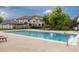 Outdoor community pool with lounge chairs surrounding the pool deck at 8707 E Florida Ave # 614, Denver, CO 80247