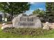 River Rock Condominiums sign with a stone monument and landscaped flowerbed at the community entrance at 8707 E Florida Ave # 614, Denver, CO 80247