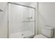 Bright bathroom features a clean, tiled shower with glass door at 18712 E 99Th Ave, Commerce City, CO 80022
