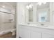 A modern bathroom with double sinks, glass enclosed shower and tiled flooring at 18712 E 99Th Ave, Commerce City, CO 80022