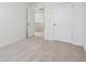 A standard carpeted bedroom with two doors, and light neutral colors at 18712 E 99Th Ave, Commerce City, CO 80022