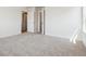 A standard carpeted bedroom with two doors, and light neutral colors at 18712 E 99Th Ave, Commerce City, CO 80022