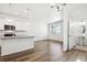 Bright, open kitchen featuring granite countertops, a breakfast bar, and modern white cabinetry at 18712 E 99Th Ave, Commerce City, CO 80022