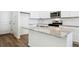 Kitchen island featuring granite countertops, stainless steel sink, and bar seating at 18712 E 99Th Ave, Commerce City, CO 80022