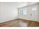 Living room boasts wood floors, abundant natural light, and is freshly painted at 18712 E 99Th Ave, Commerce City, CO 80022