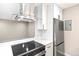 Modern kitchen features stainless steel appliances and white cabinetry at 5691 W 35Th Ave # 2B, Wheat Ridge, CO 80212