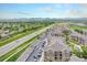 Aerial view of community with mountain views and adjacent highway at 1425 Blue Sky Cir # 15-301, Erie, CO 80516
