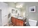 Well-lit bathroom features a double vanity, large mirror, and neutral wall color at 1425 Blue Sky Cir # 15-301, Erie, CO 80516