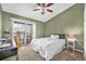 Cozy bedroom with a ceiling fan, large window, and comfortable bed at 1425 Blue Sky Cir # 15-301, Erie, CO 80516