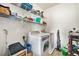 Efficient laundry room with washer, dryer, and shelving for storage at 1425 Blue Sky Cir # 15-301, Erie, CO 80516