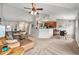 Open-concept living room featuring vaulted ceilings, plush seating, and a seamless flow into the kitchen and dining areas at 1425 Blue Sky Cir # 15-301, Erie, CO 80516