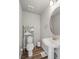 Bathroom featuring a pedestal sink, toilet and shelving for storage at 2225 Santini Trl # C, Littleton, CO 80129