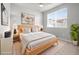 Serene bedroom featuring a platform bed, nightstands, and a large window at 2225 Santini Trl # C, Littleton, CO 80129