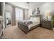 Comfortable bedroom with a large window, a bed and two night stands at 2225 Santini Trl # C, Littleton, CO 80129
