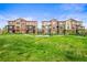 Expansive green area between modern townhomes, complete with walkways and benches at 2225 Santini Trl # C, Littleton, CO 80129